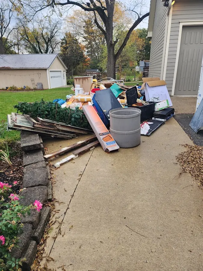 Dumpster being loaded with debris for 12 Yard Dumpster Rental in Maitland